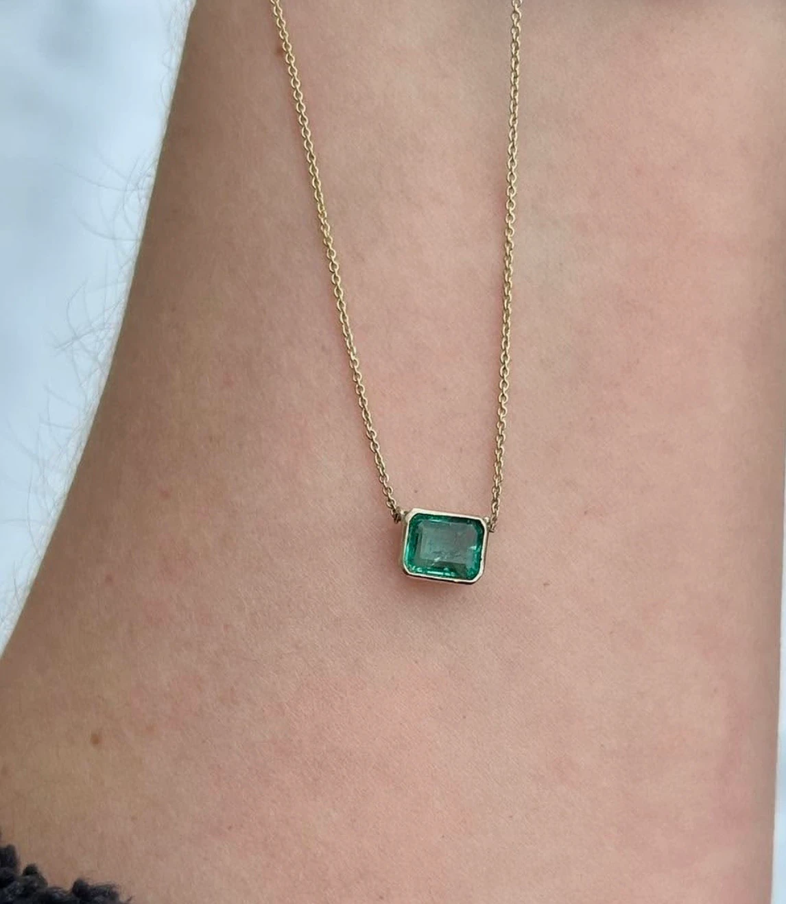 Emerald necklace worn around neck