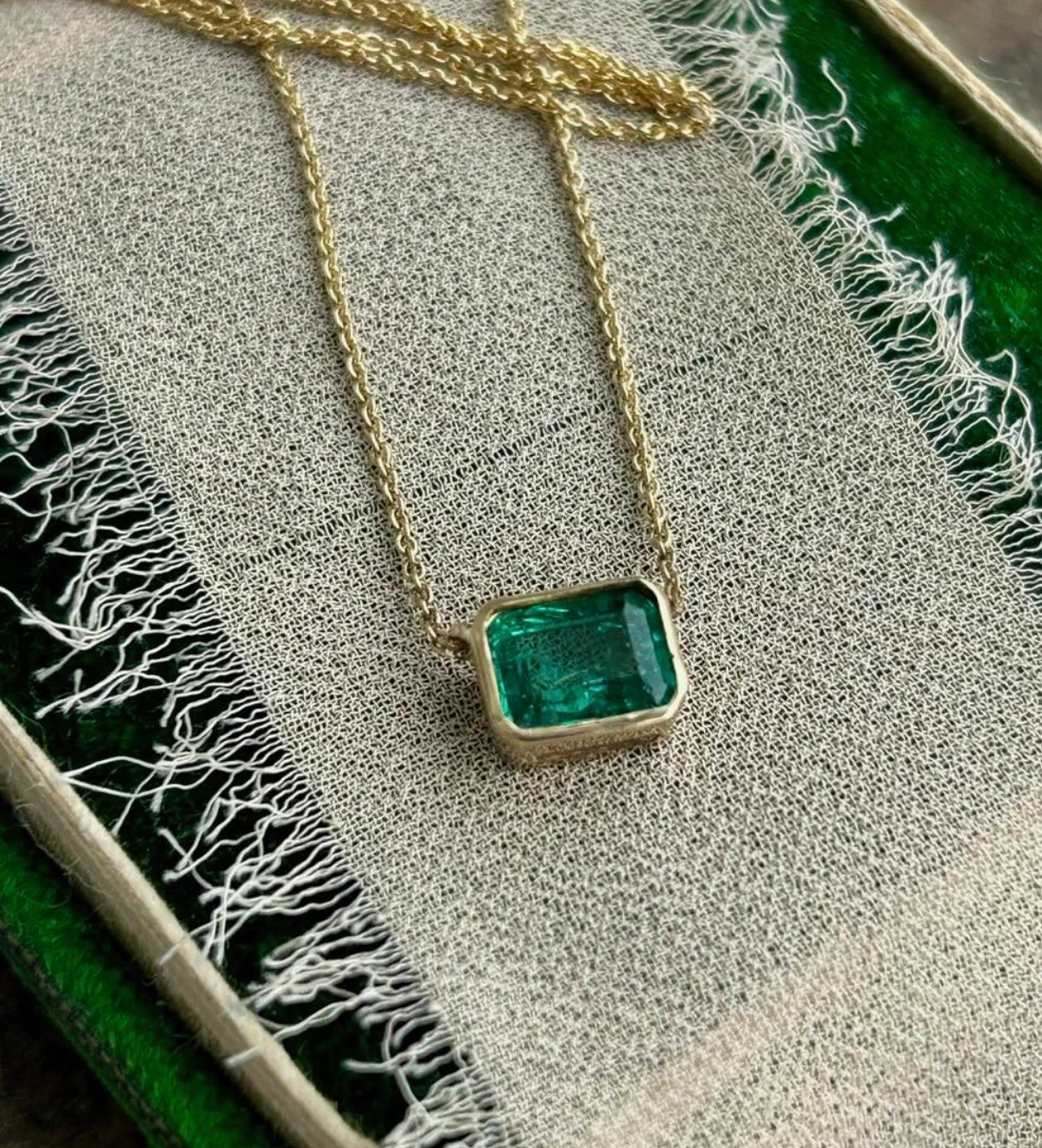 Close-up of emerald pendant on jewelry box